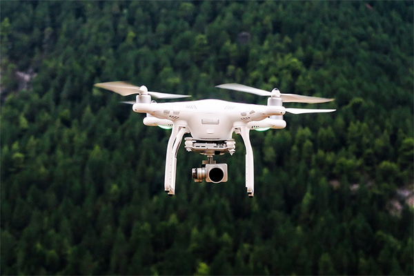 drone hovering over trees